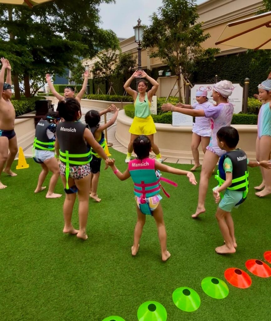 Children participating in an outdoor family fitness class led by Dr. Nair Cardoso in Macau.